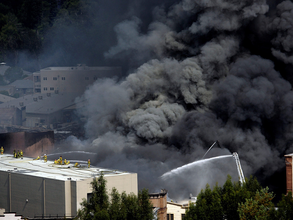 Los Angeles firefighters extinguish a fire at a building at Universal Studios in Los Angeles, Calif., on Sunday, June 1, 2008.