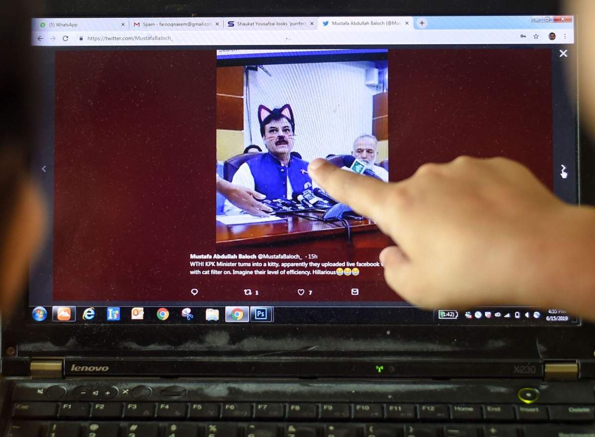 Pakistani children point at a computer screen showing a screengrab of a press conference attended by provincial Minister Shaukat Yousafzai and streamed live on social media, in Islamabad on June 15, 2019.