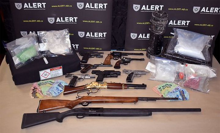 Seven people are facing more than 175 charges after 12 guns and nearly $200,000 worth of drugs were seized from a rural property in Peace River, Alta.