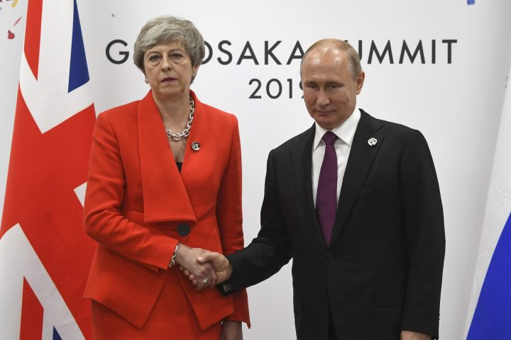 Russian President Vladimir Putin, right, and British Prime Minister Theresa May shake hands during their meeting on the sidelines of the G-20 summit in Osaka, western Japan, Friday, June 28, 2019.