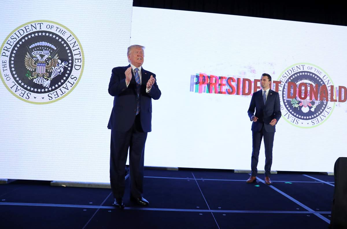 U.S. President Donald Trump takes the stage to address Turning Point USA’s Teen Student Action Summit as Turning Point USA founder Charlie Kirk looks on in Washington, U.S., July 23, 2019.