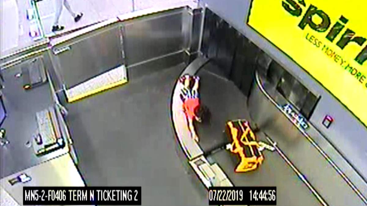Lorenzo, 2, is shown on a luggage conveyor belt at the Atlanta airport on July 22, 2019.