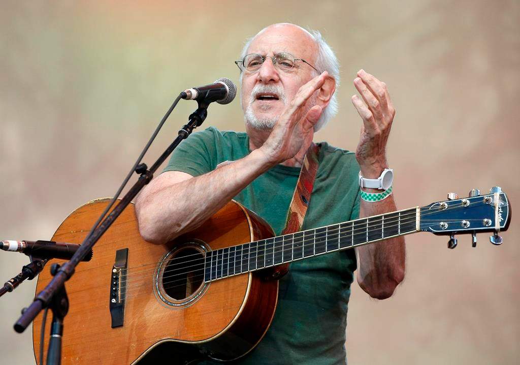 In this July 20, 2014, file photo, singer-songwriter Peter Yarrow, of the 1960's era musical trio "Peter Paul and Mary," claps and encourages the audience to sing along during a memorial tribute concert for folk icon and civil rights activist Pete Seeger at Lincoln Center's Damrosch Park in New York.