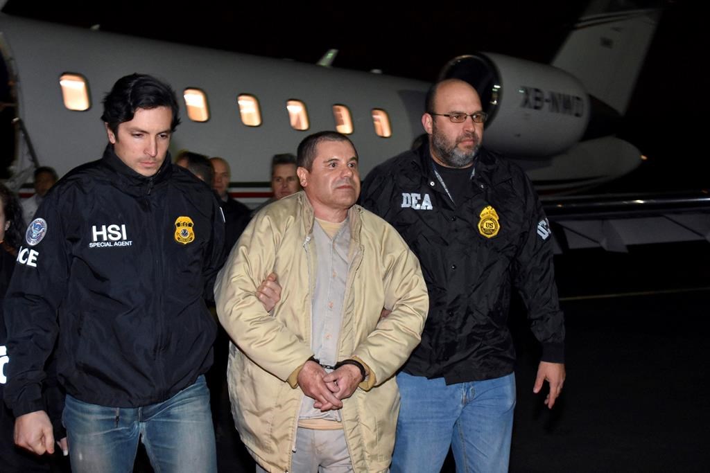 FILE – In this Jan. 19, 2017, file photo provided by U.S. law enforcement, authorities escort Joaquin ‘El Chapo’ Guzman, centre, from a plane to a waiting caravan of SUVs at Long Island MacArthur Airport, in Ronkonkoma, N.Y. Guzman, who was convicted in February 2019 on multiple conspiracy counts in an epic drug trafficking case, will be sentenced in a New York courtroom on Wednesday, July 17, 2019. (U.S. law enforcement via AP, File)
