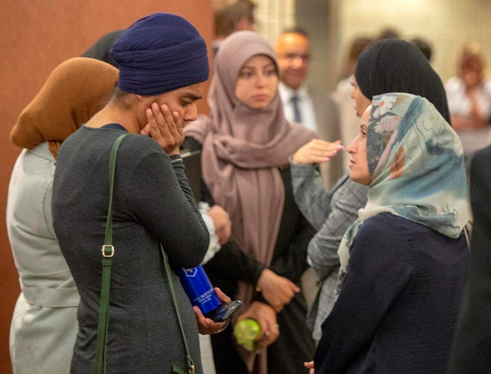 People wait to enter the courtroom for a hearing challenging Bill 21, Quebec's religious symbols law, Tuesday, July 9, 2019 in Montreal.