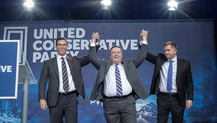 Brian Jean Jason Kenney, centre, celebrates his victory as the first official leader of the Alberta United Conservative Party with his opponents Brian Jean, right, and Doug Schweitzer in Calgary, Alta., Saturday, Oct. 28, 2017.