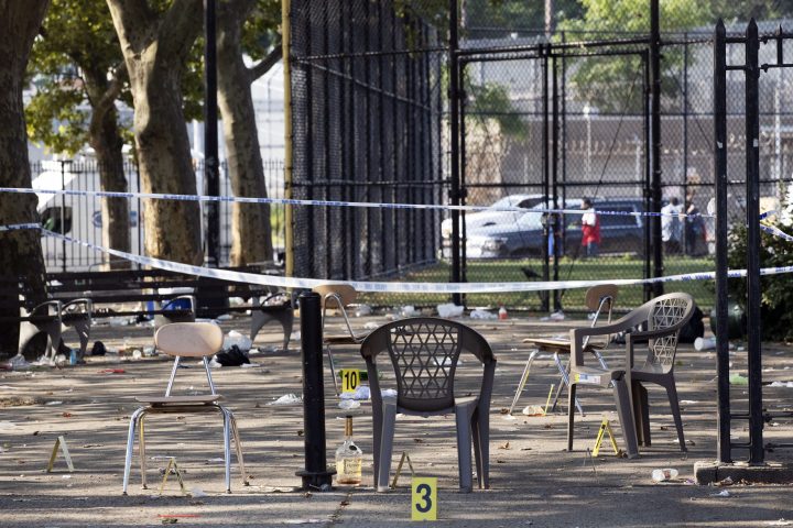 Yellow evidence markers are placed next to chairs at a playground in the Brownsville neighborhood in the Brooklyn borough of New York, Sunday, July 28, 2019.