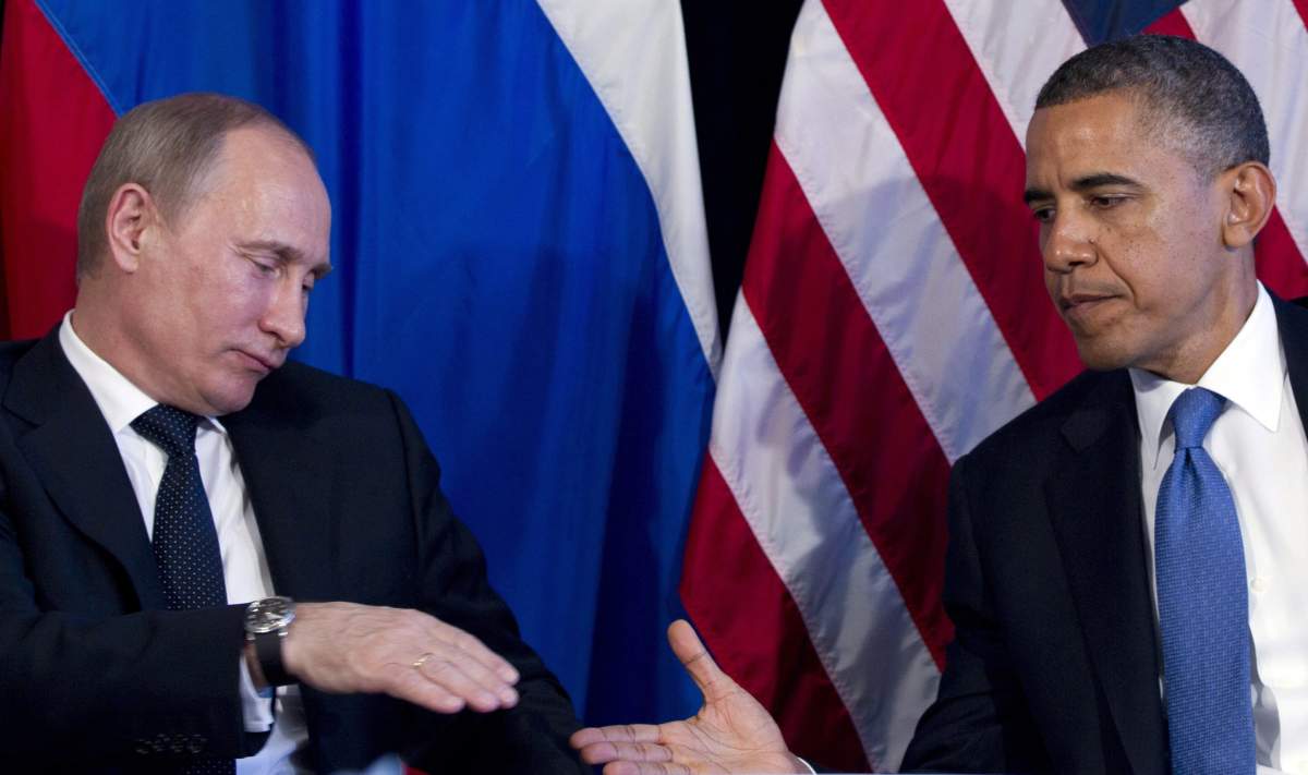 In this June 18, 2012, file photo President Barack Obama and Russias President Vladimir Putin, left, go to shake hands during their bilateral meeting at the G20 Summit in Los Cabos, Mexico.