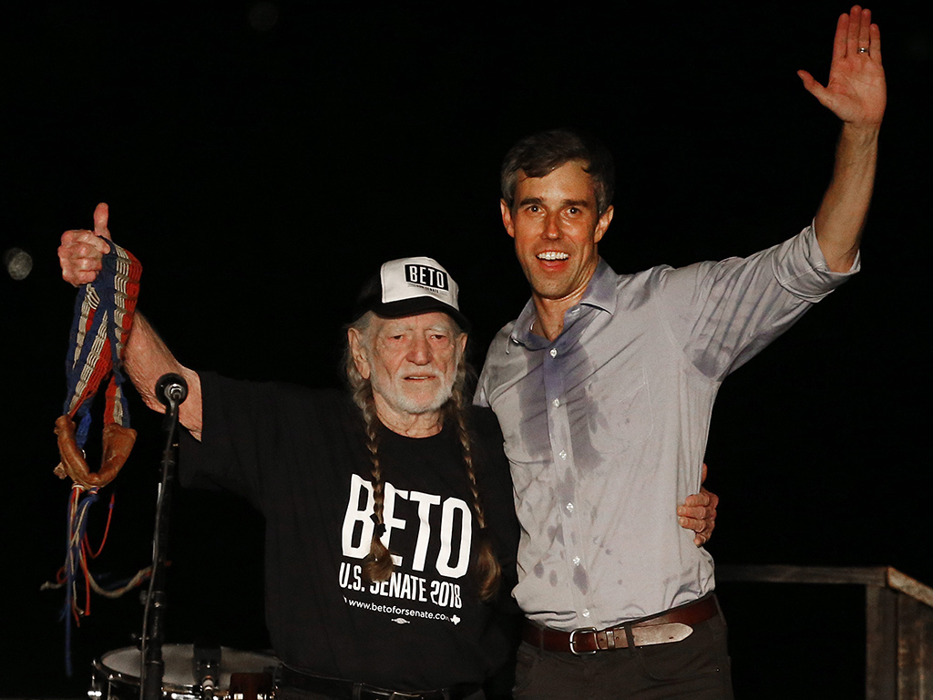 Beto O’Rourke (R) and country music legend Willie Nelson (L) wave to supporters at a Turn Out For Texas Rally in Austin, Texas, on Sept. 29, 2018.