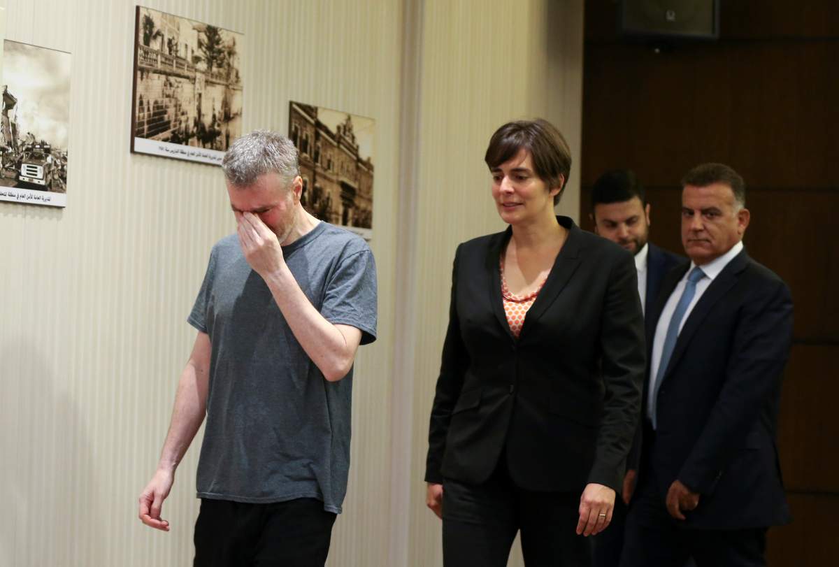 Canadian citizen, Kristian Lee Baxter, who was being held in Syria reacts as he walks next to Canadian Ambassador to Lebanon, Emmanuelle Lamoureux and Major General Abbas Ibrahim, Lebanon’s internal security chief, after being released, in Beirut, Lebanon August 9, 2019. REUTERS/Mohamed Azakir