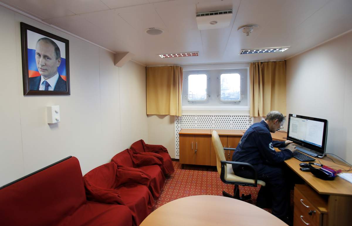 An employee of Russia’s floating nuclear power plant Akademik Lomonosov works during preparations for a 4,000-mile journey along the Northern Sea Route to Chukotka at state company Rosatomflot base in Murmansk, Russia August 22, 2019. REUTERS/Maxim Shemetov