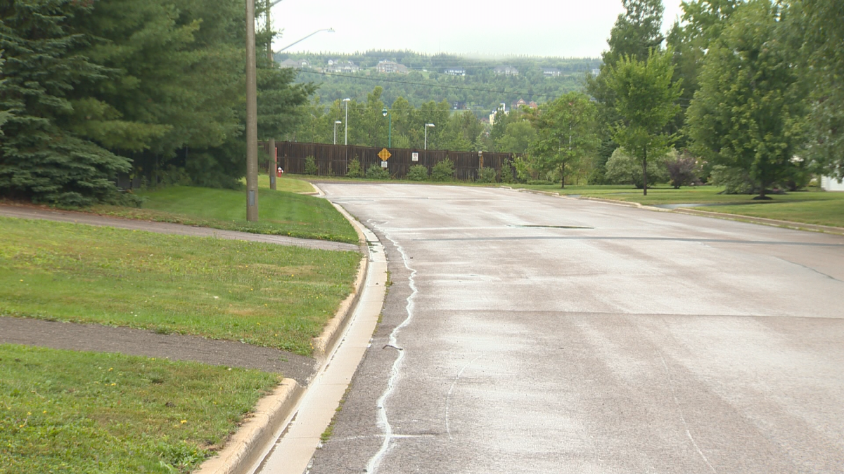 A wooden wall stands at the end of Muirfield/Twin Oaks Drive, separating the neighbourhood from Casino Drive.