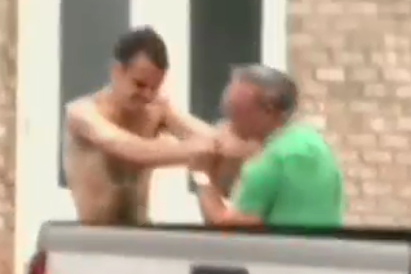 Matthew Thomas Bernard, left, is shown grappling with Lloyd Gaudlin outside the Keeling Baptist Church in Keeling, Va., in this still image from video on Aug. 27, 2019.