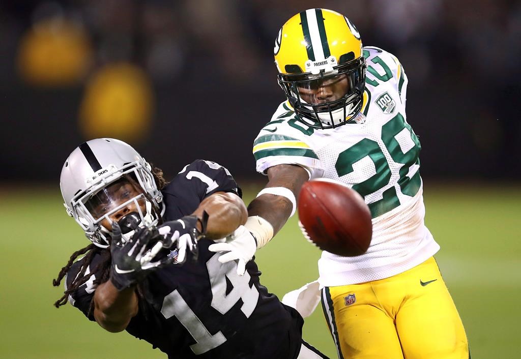 Green Bay Packers cornerback Josh Hawkins (28) breaks up a pass intended for Oakland Raiders wide receiver Keon Hatcher (14) during the second half of an NFL preseason football game in Oakland, Calif., Friday, Aug. 24, 2018. The Raiders and Blue Bombers are hosting a viewing party for a NFL preseason game in Winnipeg this week.