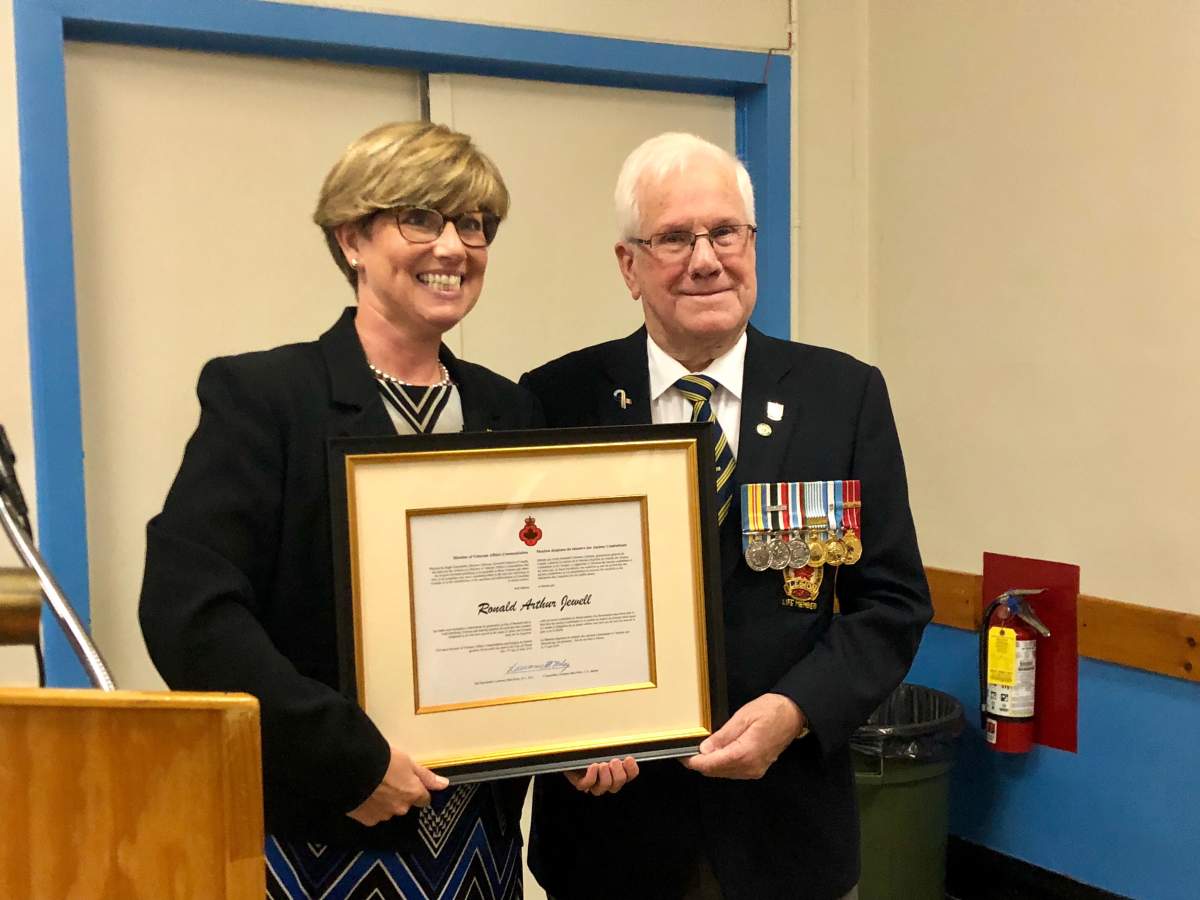 Karen Vecchio, Member of Parliament for Elgin-Middlesex-London, presenting Ronald Jewell with Minister of Vetrans the Affairs Commendation for his work with the Canadian Legion.