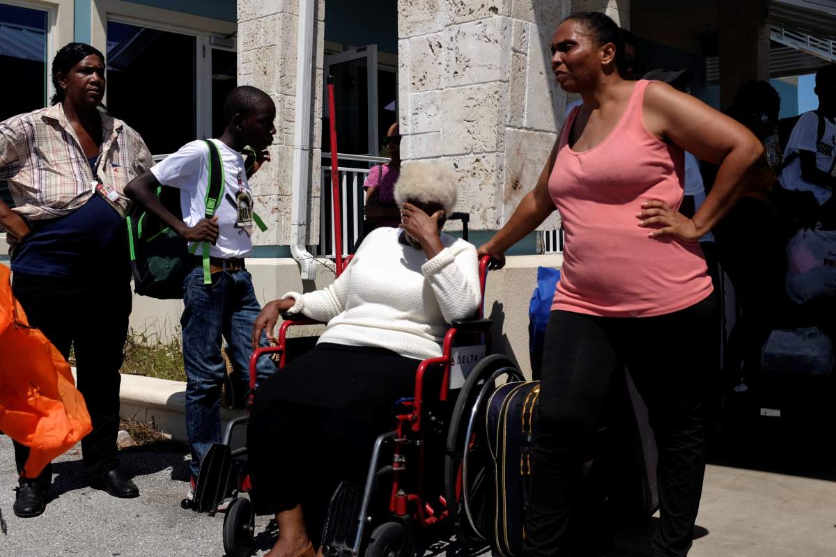 People wait to be evacuated at the Leonard M. Thompson airport after hurricane Dorian hit the Abaco Islands in Marsh Harbour, Bahamas. (Reuters)
