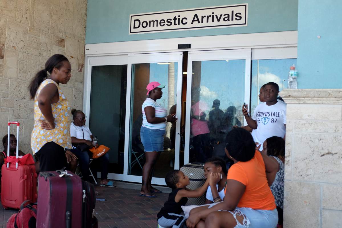 People wait to be evacuated at the Leonard M. Thompson airport after hurricane Dorian hit the Abaco Islands in Marsh Harbour, Bahamas. (Reuters)