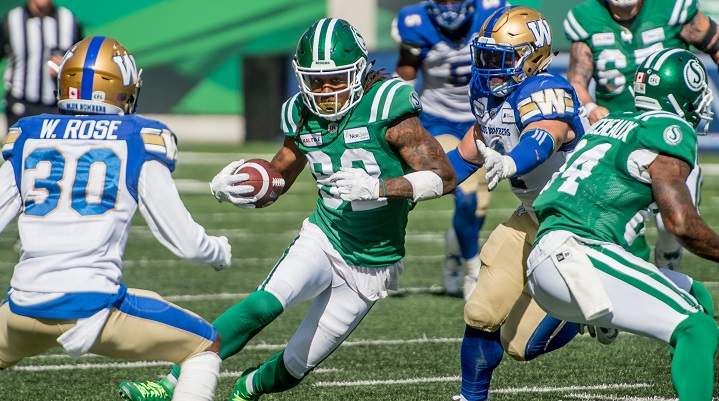 Saskatchewan Roughriders wide receiver Naaman Roosevelt (82) runs the ball under pressure from the Winnipeg Blue Bombers defence during second half CFL action in Regina.  The Saskatchewan Roughriders defeated the Winnipeg Blue Bombers 19-17 on Sept 1, 2019. 