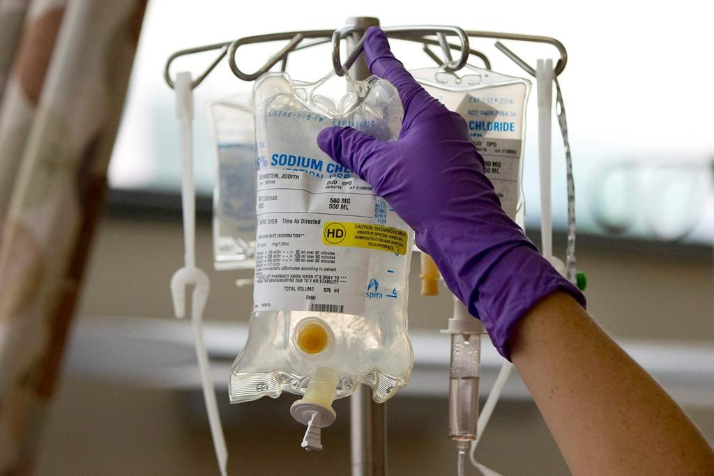 In this Tuesday, Aug. 4, 2015 file photo, a nurse places a patient's chemotherapy medication on an intravenous stand at a hospital.