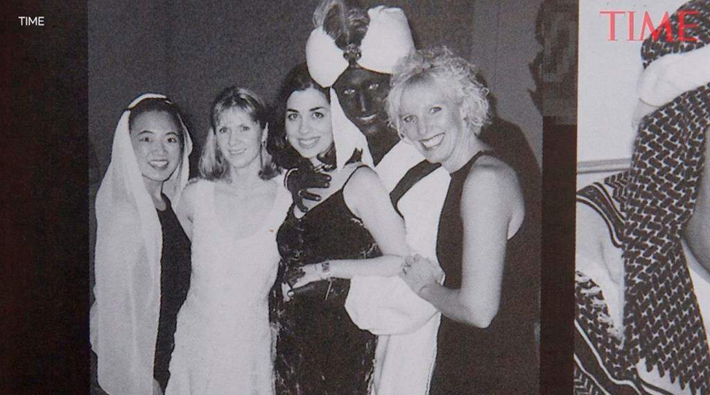 A photo showing Prime Minister Justin Trudeau, second from right, at a 2001 costume party – his hands and face blackened with makeup — was published by Time Magazine Wednesday. (THE CANADIAN PRESS/HO – TIME)