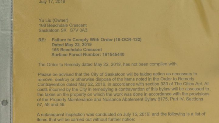 A demolition notice from the City of Saskatoon is posted on the front door of the Beechdale Crescent property.