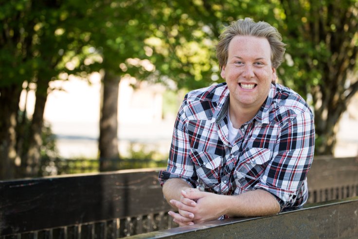Former constituency assistant Desmond Devnich has been charged with two counts of fraud over $5000.
