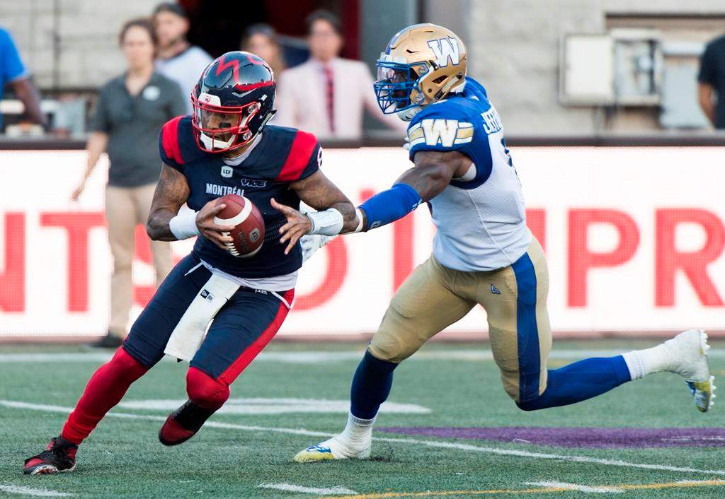 Montreal Alouettes quarterback Vernon Adams Jr., left, breaks away from Winnipeg Blue Bombers linebacker Adam Bighill during second half CFL football action in Montreal, Saturday, September 21, 2019. The CFL is reviewing the helmet-swinging incident Saturday involving Adams Jr. and Bighill.THE CANADIAN PRESS/Graham Hughes.