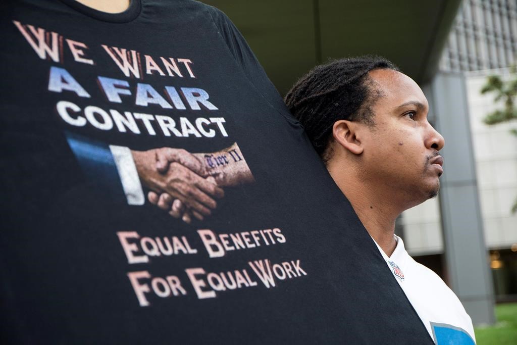Sean Crawford, of United Auto Workers 598, rallies outside the Marriott Renaissance Hotel while the UAW GM Council holds a meeting inside the hotel in Detroit, Sunday Sept. 15, 2019.