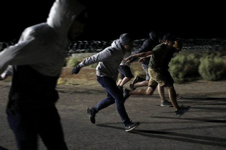 People do the “Naruto run” at the gates of Area 51 on Sept. 20, 2019.