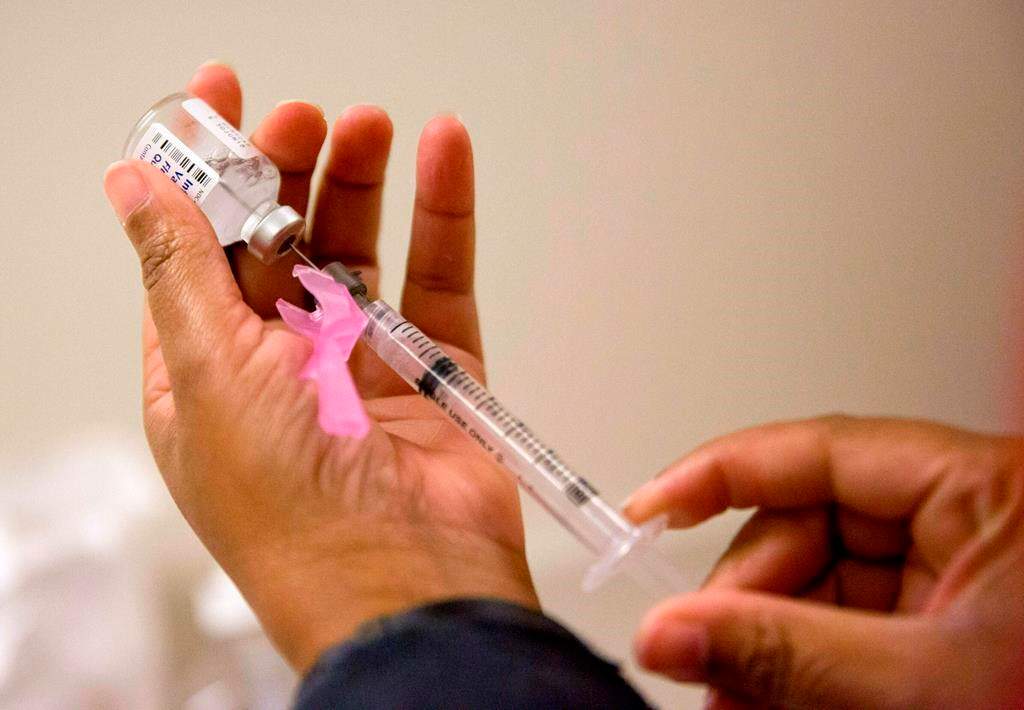 A nurse prepares the flu shot in this file photo.