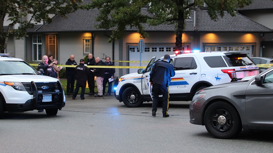 Surrey RCMP and homicide investigators outside a Newton home on Oct. 4, 2019, where a woman was found dead and a man was arrested.