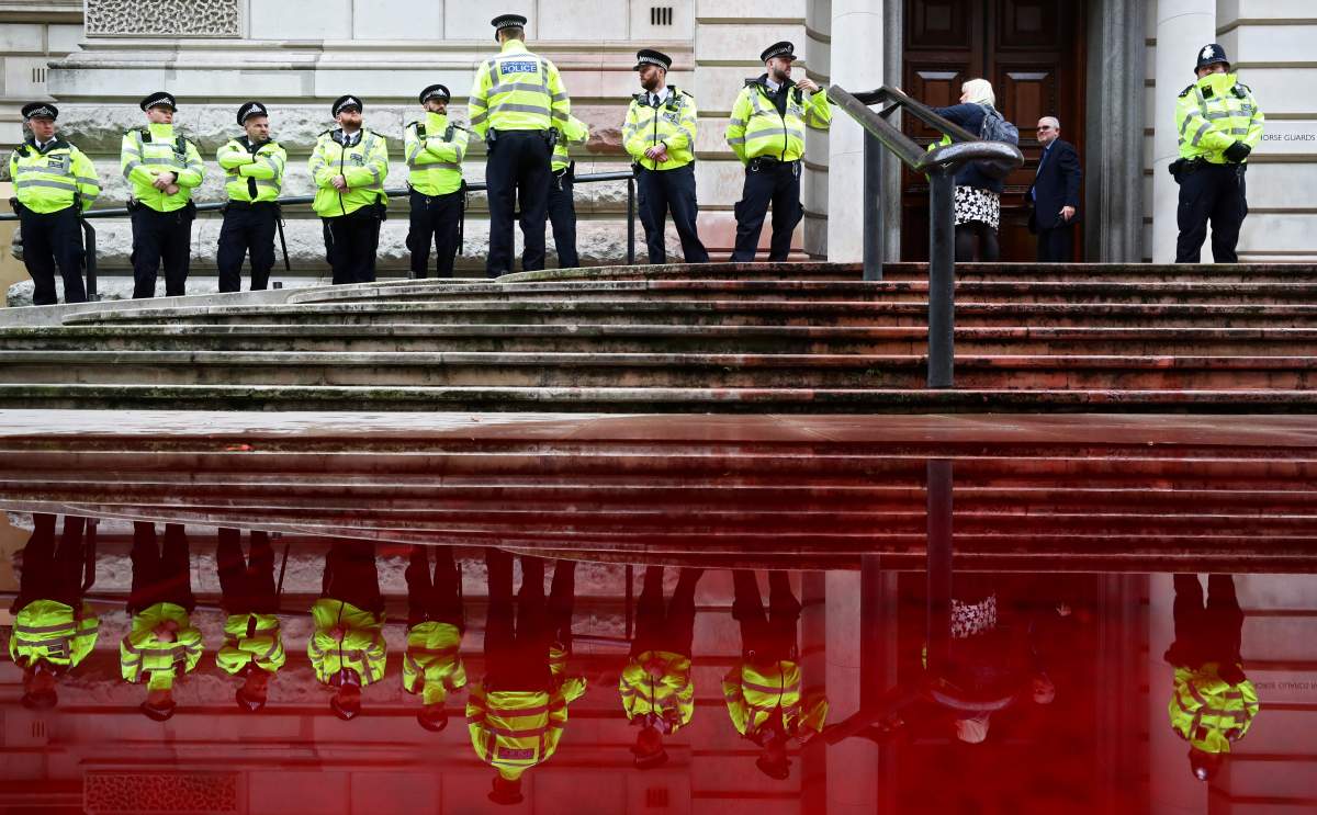Police stands in front of the Treasury building during an Extinction Rebellion protest in London, Britain October 3, 2019. REUTERS/Simon Dawson