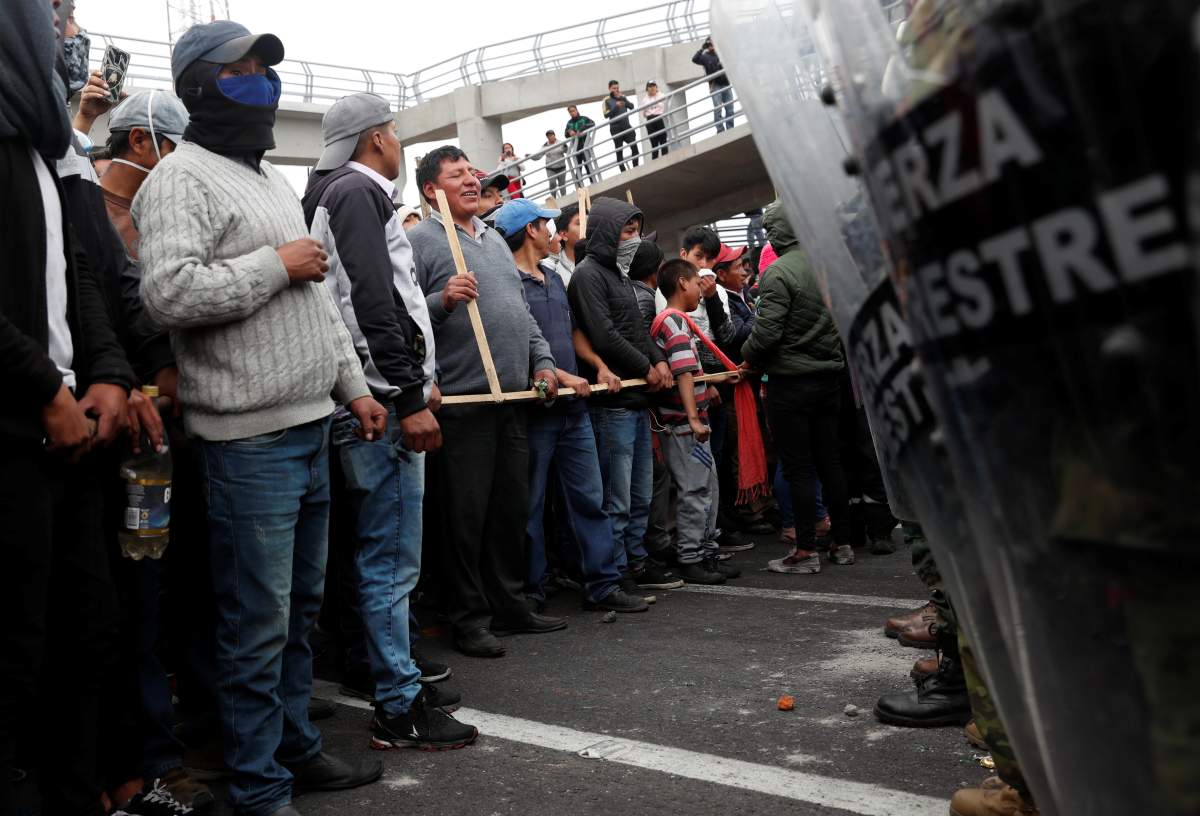 People face off soldiers as they block a road during protests after Ecuador’s President Lenin Moreno’s government ended four-decade-old fuel subsidies, in Lasso, Ecuador, October 6, 2019.