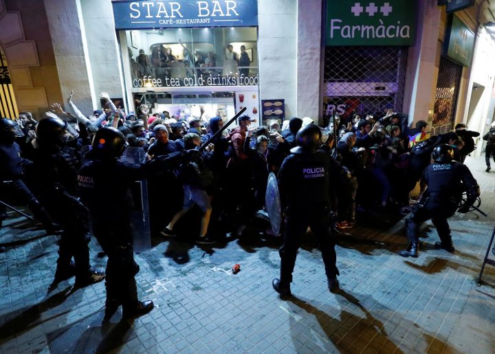 Police officers scuffle with demonstrators during protest after a verdict in a trial over a banned Catalonia’s independence referendum, near Catalan Interior Ministry in Barcelona, Spain, October 16, 2019.