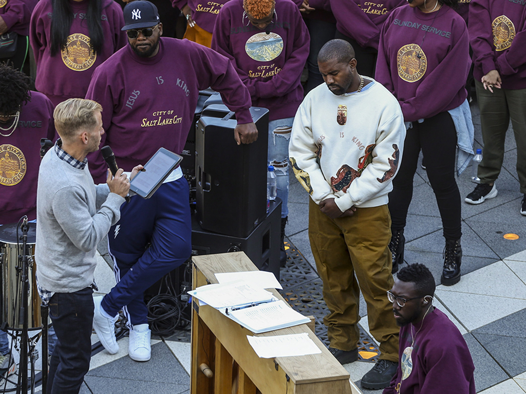 Kanye West (R) bows his head in prayer during his ‘Sunday Service’ at The Gateway in Salt Lake City, Utah, on Saturday, Oct. 5, 2019.