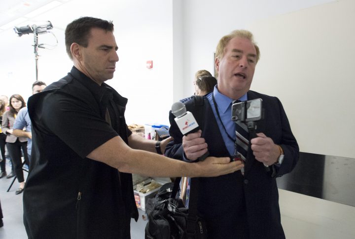 A member of the RCMP removes David Menzies, a reporter from Rebel Media, during a campaign stop for Conservative leader Andrew Scheer at the Abilities Centre in Whitby, Ont. Monday, Sept. 30, 2019. 
