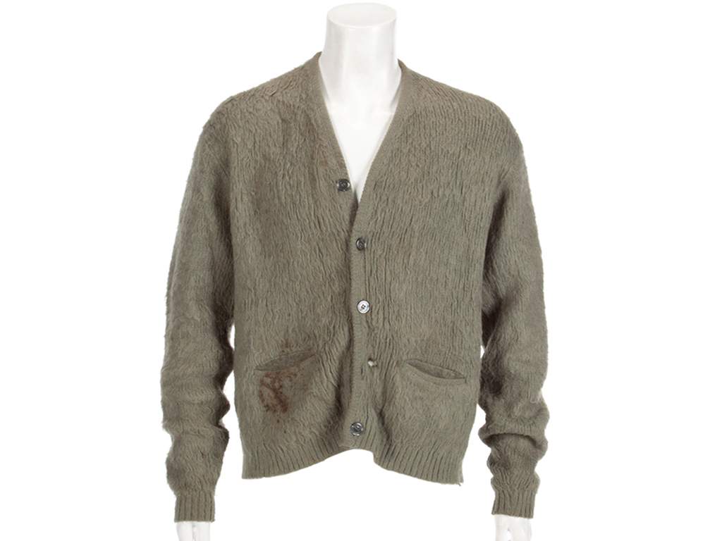 This image released by Julien’s Auctions shows an olive green cardigan sweater worn by Nirvana frontman Kurt Cobain during Nirvana’s MTV’s ‘Unplugged’ performance. The sweater, along with Cobain’s custom Fender guitar, is among many rock ‘n’ roll items up for auction on Oct. 25 and 26.