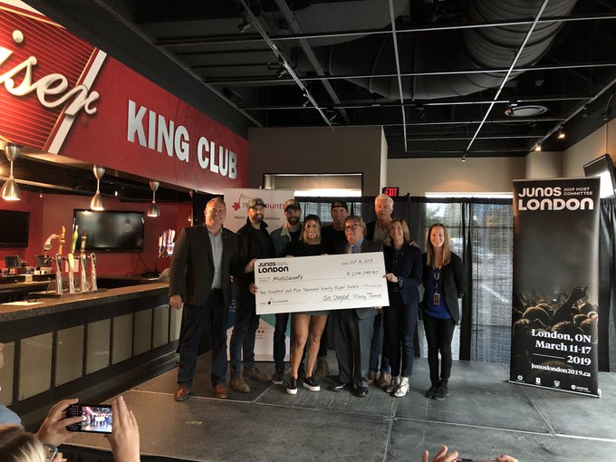 Officials are joined by The Reklaws and Dean Brody to present a cheque of more than $200,000 from the 2019 London JUNOS Host Committee to MusiCounts.