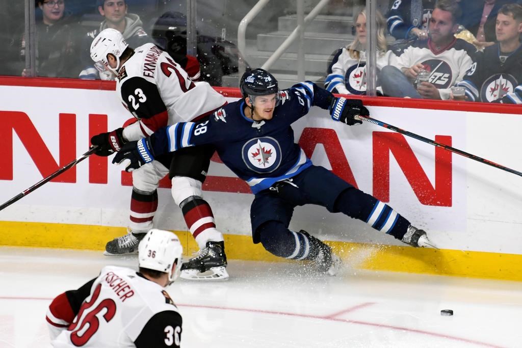 Winnipeg Jets' Jack Roslovic (28) and Arizona Coyotes' Oliver Ekman-Larsson (23) collide during third period NHL action in Winnipeg on Tuesday, Oct. 15, 2019. THE CANADIAN PRESS/Fred Greenslade.