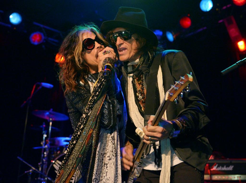 In this April 8, 2014 file photo, Steven Tyler, left, and Joe Perry of Aerosmith perform at the Whisky A Go Go in Los Angeles, Calif.