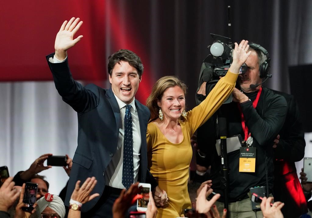 Liberal Leader Justin Trudeau and wife Sophie Gregoire Trudeau wave as they go on stage at Liberal election headquarters in Montreal, Monday, Oct. 21, 2019. THE CANADIAN PRESS/Paul Chiasson