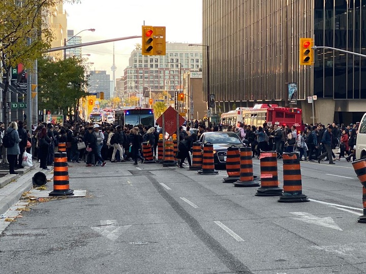Commuters waiting for shuttle buses after part of Line 1 shut down Tuesday afternoon.