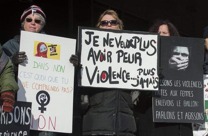 Several women attend a demonstration in Montreal, Friday, Dec. 6, 2013, to highlight violence against women. Fourteen women lost their lives at the hands of a gunman at the École Polytechnique on this day in 1989.