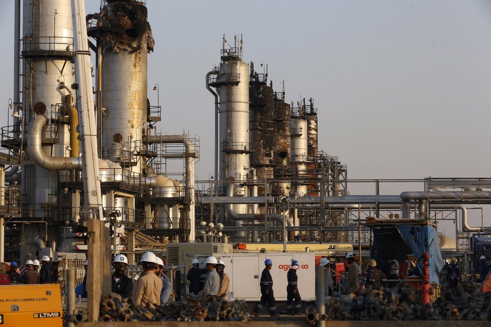 FILE - In this Sept. 20, 2019, file photo, taken during a trip organized by Saudi information ministry, workers fix the damage in Aramco's oil separator at processing facility after the recent Sept. 14 attack in Abqaiq, near Dammam in the Kingdom's Eastern Province.