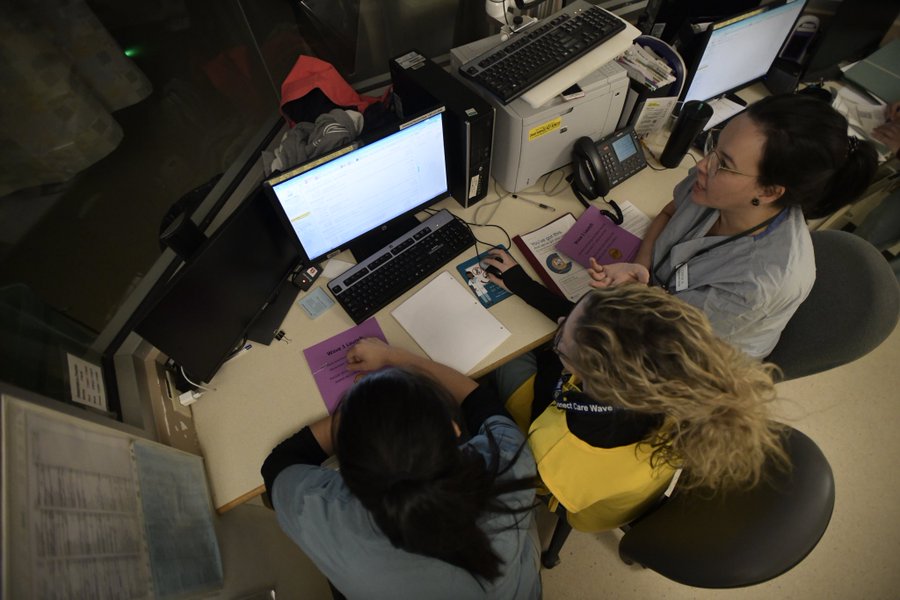 Registered nurses Stephanie Sarafinchen, Laura Vey and Tanya Gladue review assessments on the new Connect Care interface in the burn unit at the University of Alberta Hospital on Oct. 4, 2019.