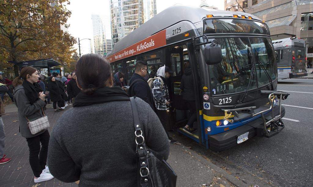 Passengers board a bus in downtown Vancouver, Friday, November, 1, 2019.