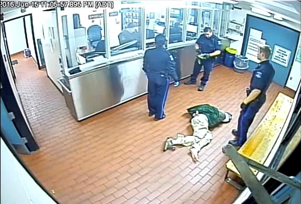 Corey Rogers lies on the floor under police custody at the Halifax police station wearing a spit hood at about 11 p.m. on June 15, 2016 in this still image taken from surveillance video provided by Nova Scotia Courts. THE CANADIAN PRESS/HO, Province of Nova Scotia Courts