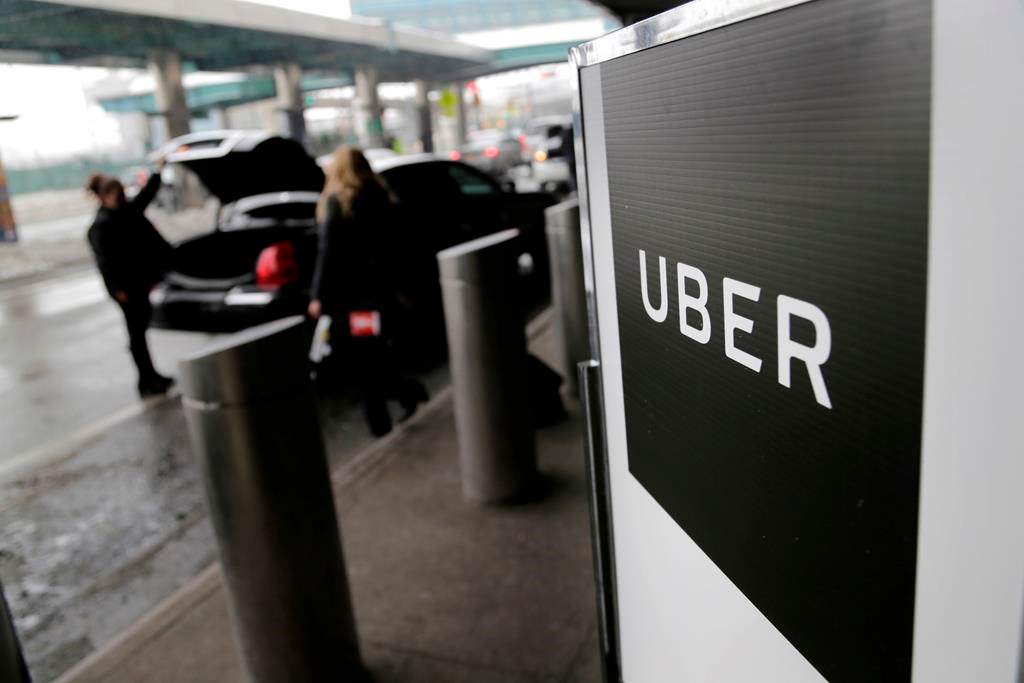 A sign marks a pickup point for the Uber car service.