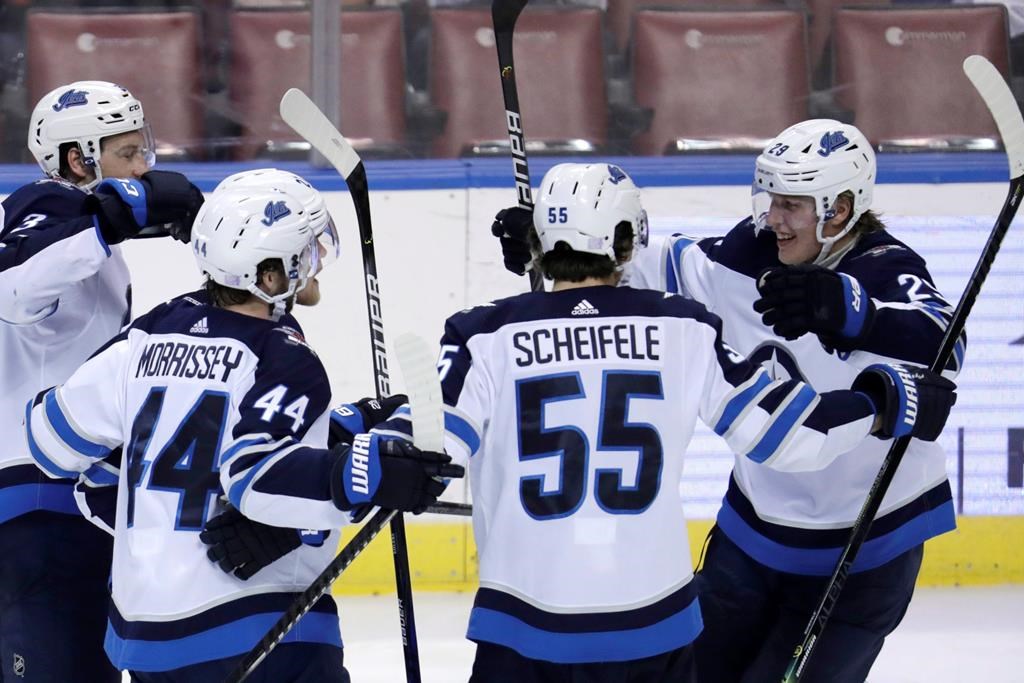 Winnipeg Jets right-wing Patrik Laine, right, celebrates with defenceman Josh Morrissey (44) and centre Mark Scheifele (55) after scoring a goal during the third period of an NHL hockey game against the Florida Panthers, Thursday, Nov. 14, 2019, in Sunrise, Fla.