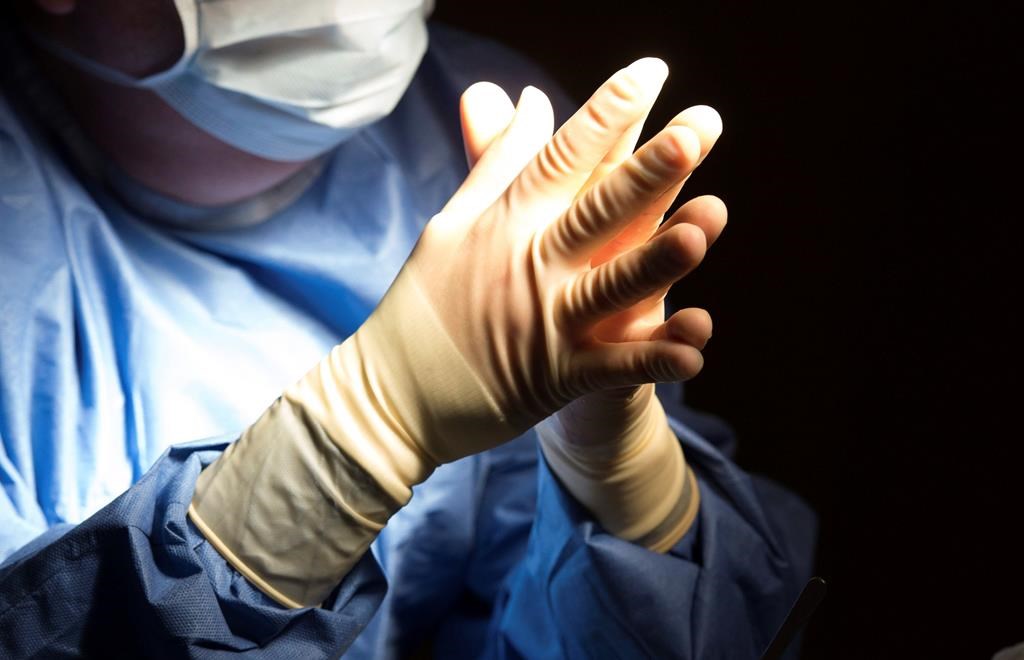 FILE - In this Tuesday, June 28, 2016 file photo, a doctor prepares for a surgical procedure at a hospital in Washington. 